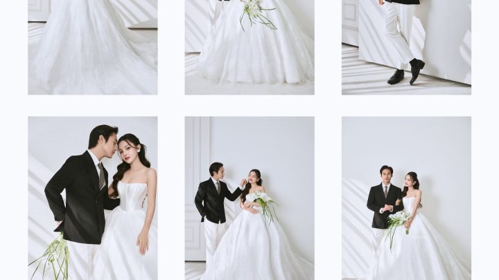 Cặp đôi chụp ảnh cưới tại studio với bối cảnh trắng tối giản, cô dâu lộng lẫy trong váy cưới trắng cúp ngực, chú rể lịch lãm với vest đen quần trắng, mang đến phong cách Hàn Quốc hiện đại và sang trọng với tông màu trắng tinh khôi.