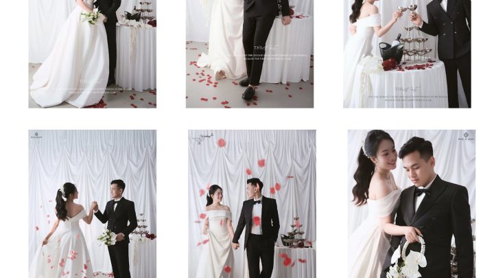 Cặp đôi lãng mạn trong studio với phông rèm trắng tinh khôi, cô dâu diện váy cưới trắng trễ vai thanh lịch và chú rể lịch lãm trong vest đen, tạo nên phong cách hiện đại, sang trọng với tông màu chủ đạo trắng, đen và điểm nhấn đỏ của hoa hồng.
